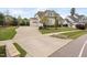 Home exterior featuring a large driveway, well-manicured lawn, and attractive landscaping at 7825 Green Hope School Rd, Cary, NC 27519