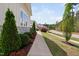 Well-maintained exterior with manicured landscaping, shrubs, and a sidewalk at 7825 Green Hope School Rd, Cary, NC 27519