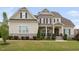 Beautiful two-story home with stone accents, covered porch, manicured lawn and tasteful landscaping at 7825 Green Hope School Rd, Cary, NC 27519