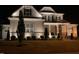 Well-lit two-story home boasts an elegant front yard and classic architectural details at 7825 Green Hope School Rd, Cary, NC 27519