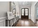 Grand foyer features hardwood floors, a decorative mirror, and a modern chandelier fixture at 7825 Green Hope School Rd, Cary, NC 27519