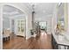 Elegant foyer with hardwood floors, staircase, arched doorway, and decorative display cabinet at 7825 Green Hope School Rd, Cary, NC 27519