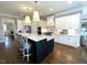 Bright kitchen with a large island, seating, and stainless steel appliances at 7825 Green Hope School Rd, Cary, NC 27519