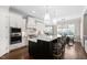Modern kitchen boasts stainless steel appliances, a large island, and white cabinets at 7825 Green Hope School Rd, Cary, NC 27519