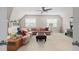 Spacious living room with a comfortable, sectional couch, ceiling fan, and natural light from two windows at 7825 Green Hope School Rd, Cary, NC 27519