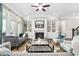 Bright living room featuring a fireplace, built-in shelving, and elegant decor at 7825 Green Hope School Rd, Cary, NC 27519