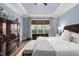 This main bedroom features tray ceilings, a ceiling fan, beautiful floors, and a view to the outdoors at 7825 Green Hope School Rd, Cary, NC 27519