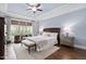 This main bedroom features a neutral color palette, tray ceilings, beautiful floors, and a ceiling fan at 7825 Green Hope School Rd, Cary, NC 27519
