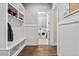 The mudroom features a bench and storage adjacent to a doorway leading into the laundry room at 7825 Green Hope School Rd, Cary, NC 27519