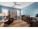 Cozy office featuring blue walls, a ceiling fan, an accent rug, and a built-in bookshelf at 7825 Green Hope School Rd, Cary, NC 27519