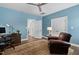 Spacious office features wood floors, blue walls, and a comfortable leather armchair at 7825 Green Hope School Rd, Cary, NC 27519