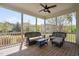 Relax on this screened porch with comfortable seating and a ceiling fan, perfect for enjoying the outdoors at 7825 Green Hope School Rd, Cary, NC 27519