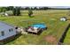 Expansive backyard with an above-ground pool, wooden deck, and ample green space, perfect for outdoor enjoyment at 82 Sommerset Dr, Clayton, NC 27520
