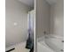Bathroom featuring a white tub and a shower with a forest shower curtain at 82 Sommerset Dr, Clayton, NC 27520