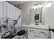 Bathroom featuring an eye-catching shower curtain, toilet, and sink with cabinet at 82 Sommerset Dr, Clayton, NC 27520
