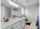 Bathroom displaying a dual sink vanity with dark hardware, and a window at 82 Sommerset Dr, Clayton, NC 27520