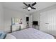 Bedroom featuring a ceiling fan, dressing table, and view into the laundry area at 82 Sommerset Dr, Clayton, NC 27520