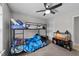 Bedroom featuring bunk beds, a ceiling fan, and a reptile tank with stand at 82 Sommerset Dr, Clayton, NC 27520