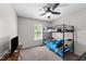 Bedroom displaying a bunk bed, window with blinds, and mounted television at 82 Sommerset Dr, Clayton, NC 27520