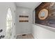 Welcoming foyer with coat hooks, decorative mirror, and a bright front door, creating a warm entry at 82 Sommerset Dr, Clayton, NC 27520