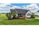 Inviting home with a manicured lawn, complemented by lush landscaping and charming architectural details at 82 Sommerset Dr, Clayton, NC 27520