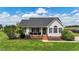 Charming single-story home featuring a welcoming front porch, well-manicured lawn, and inviting curb appeal at 82 Sommerset Dr, Clayton, NC 27520