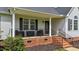 Charming front porch with comfortable seating, perfect for relaxing and enjoying the outdoors at 82 Sommerset Dr, Clayton, NC 27520