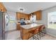 Charming eat-in kitchen featuring wood cabinets, stainless steel appliances, and a breakfast bar at 82 Sommerset Dr, Clayton, NC 27520