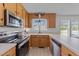 Kitchen featuring wood cabinets, stainless steel appliances, and white countertops at 82 Sommerset Dr, Clayton, NC 27520