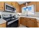 Close-up of a kitchen featuring wood cabinets and stainless steel appliances at 82 Sommerset Dr, Clayton, NC 27520
