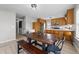 Kitchen with wooden table, benches, stainless steel appliances, and adjacent laundry room, perfect for easy living at 82 Sommerset Dr, Clayton, NC 27520