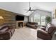 Comfortable living room features a ceiling fan, vaulted ceiling, and wood-burning fireplace at 82 Sommerset Dr, Clayton, NC 27520