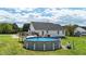 Enjoy outdoor living with a refreshing above-ground pool and deck area, ideal for summer fun at 82 Sommerset Dr, Clayton, NC 27520