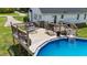 Inviting backyard features a pool and deck with cozy seating, ideal for relaxing and entertaining guests at 82 Sommerset Dr, Clayton, NC 27520