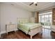 Charming bedroom with hardwood floors, tray ceiling, and sliding glass doors to outdoor living area at 85 Bramble Ln, Clayton, NC 27527