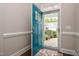 View of the front entrance with a blue door and a glimpse of the neighborhood outside at 85 Bramble Ln, Clayton, NC 27527