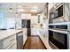 Modern kitchen featuring white cabinets, stainless steel appliances, and a central island at 85 Bramble Ln, Clayton, NC 27527