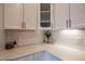 Bright kitchen featuring white cabinets, subway tile backsplash, and quartz countertops at 85 Bramble Ln, Clayton, NC 27527