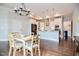 Open-concept kitchen and dining area with modern lighting and stainless steel appliances at 85 Bramble Ln, Clayton, NC 27527