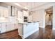 Bright kitchen with white cabinetry, a kitchen island, and hardwood floors at 85 Bramble Ln, Clayton, NC 27527