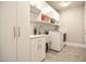 Laundry room with cabinets, utility sink, washer, and dryer at 85 Bramble Ln, Clayton, NC 27527