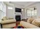 Bright living room with fireplace and open layout to a sun room at 85 Bramble Ln, Clayton, NC 27527