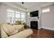 Cozy living room with fireplace, trey ceiling and natural light from the windows at 85 Bramble Ln, Clayton, NC 27527