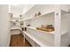 Walk-in pantry with wood floors and custom white shelving and storage at 85 Bramble Ln, Clayton, NC 27527