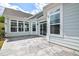 Rear patio with a beautiful stamped concrete design, complemented by large windows and a sliding glass door at 85 Bramble Ln, Clayton, NC 27527