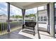 Inviting screened porch with tiled floor, seating, and serene neighborhood views for relaxation at 85 Bramble Ln, Clayton, NC 27527