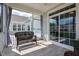 Covered porch with tiled floor, seating, and views of the community, perfect for relaxing or entertaining at 85 Bramble Ln, Clayton, NC 27527