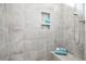 Tiled shower with built-in shelves, seat, and modern showerhead for luxurious bathing experience at 85 Bramble Ln, Clayton, NC 27527