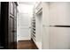 Organized walk-in closet with shelves, hanging rods, and dark wood flooring for functionality and style at 85 Bramble Ln, Clayton, NC 27527
