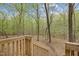 Wood stairs leading into the backyard, with lush mature trees providing lots of privacy at 922 Royal Oaks Dr, Durham, NC 27712